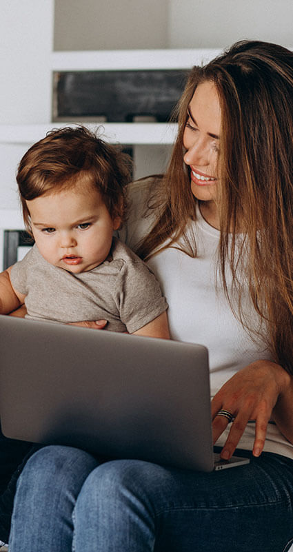 Eine Frau überprüft an ihrem Laptop die Mindestanforderungen, um von einer Banken einen Kredit zu erhalten